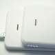 The power bank charges on the pad using a series of metal pins instead of wireless power transfer.
